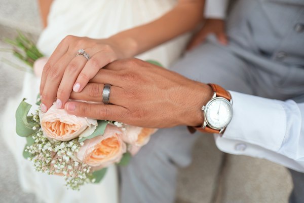 Couple hands with bouquet
